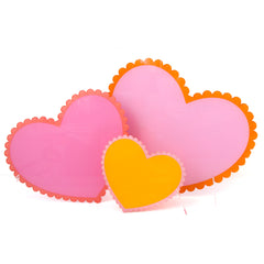 Pink, orange, and yellow scalloped edge acrylic hearts